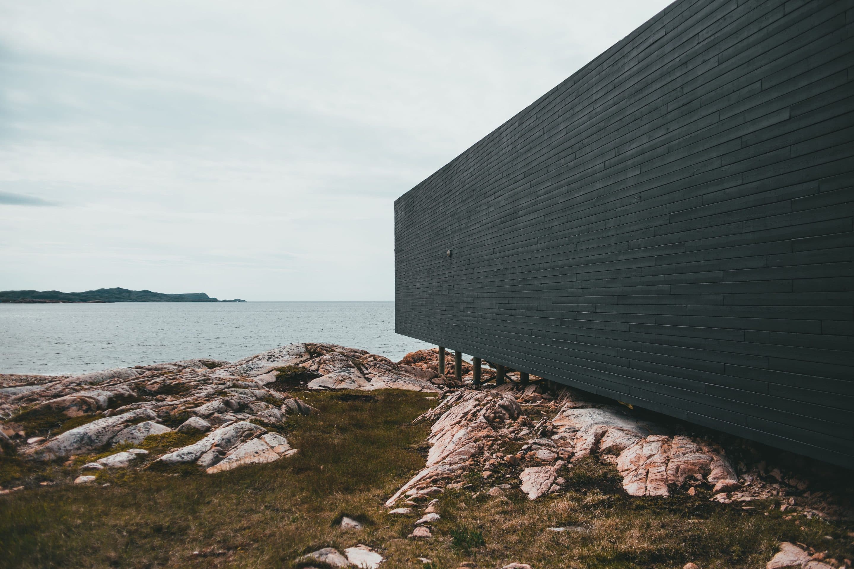 A coastal timber house, seen from the garden in afternoon light.